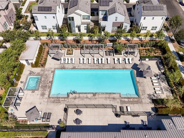 an aerial view of a house with a yard and lake view