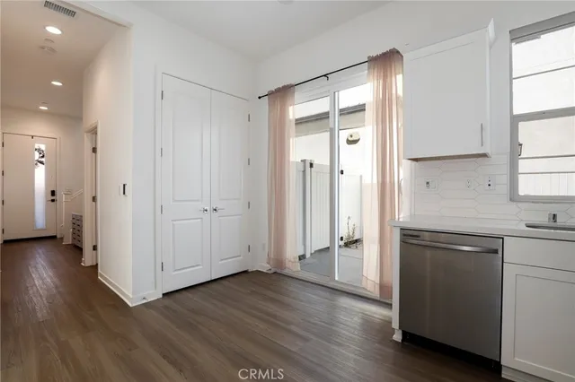 a view of a kitchen with a sink and a refrigerator