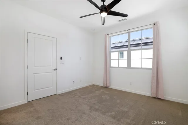 an empty room with windows and entrance