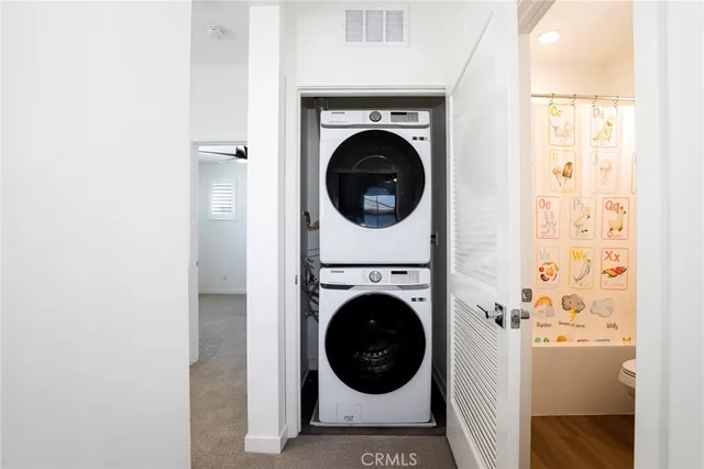 a view of a hallway with washer and dryer