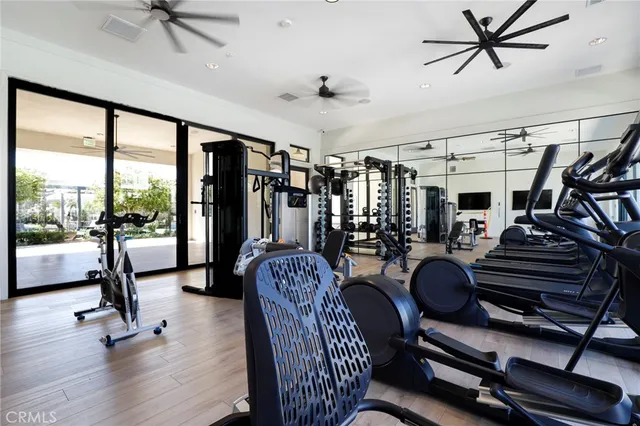 a view of a livingroom with furniture a ceiling fan and windows