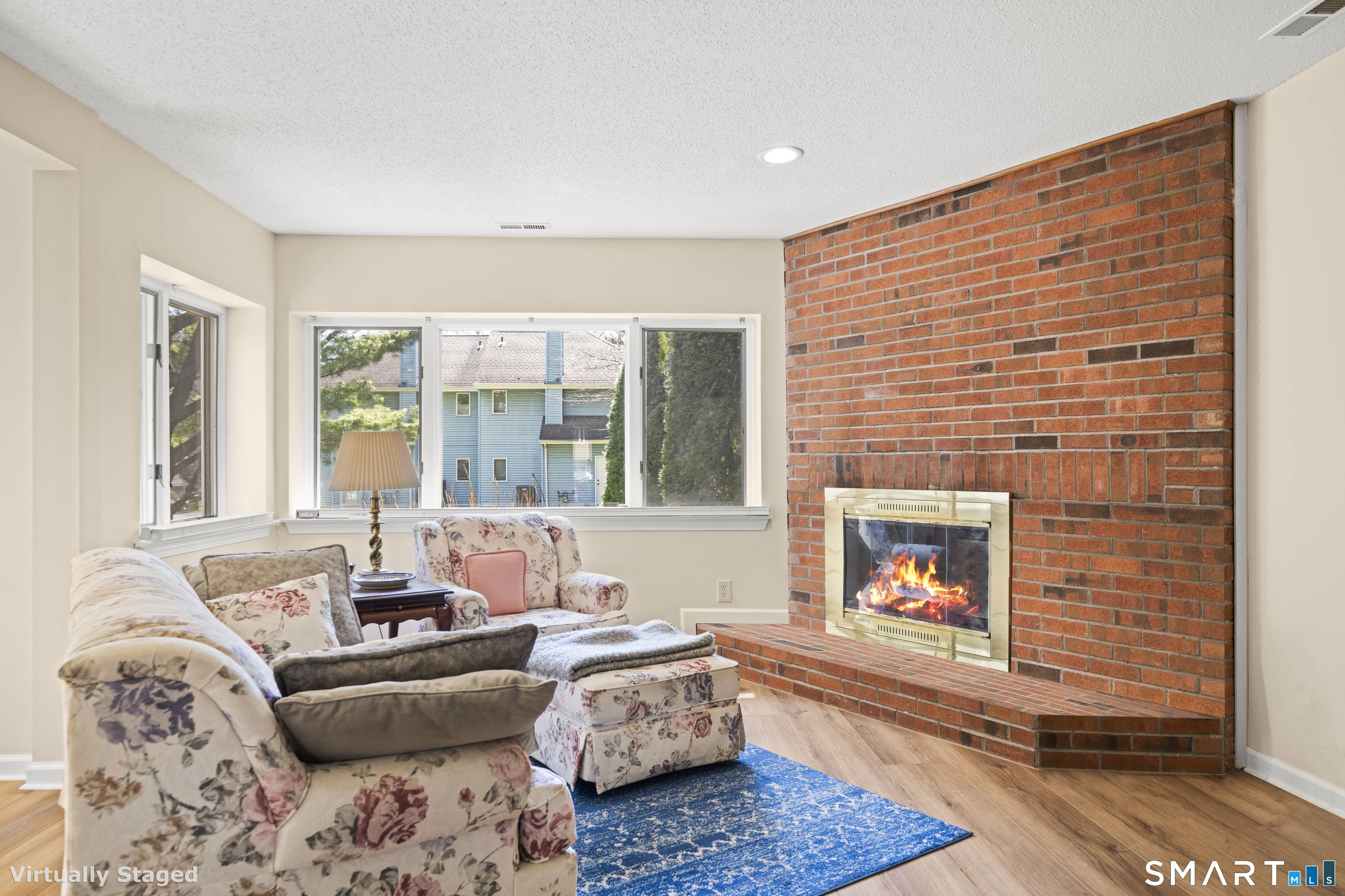 230 East Bass Lane, Unit 230 Suffield, CT 06078 - Photo 12 of 35 a living room with furniture and a fireplace