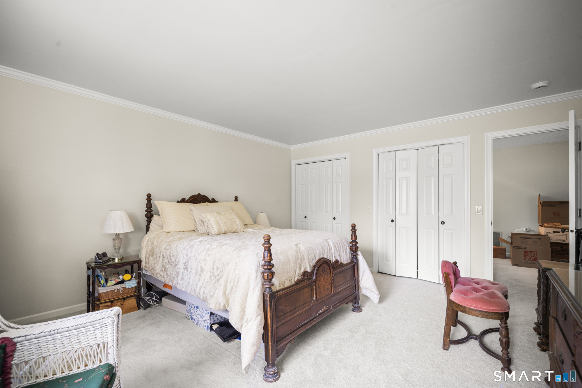 230 East Bass Lane, Unit 230 Suffield, CT 06078 - Photo 18 of 35 a bed room with a bed and chair