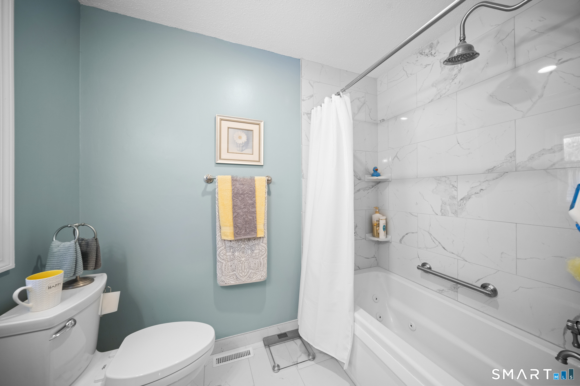 230 East Bass Lane, Unit 230 Suffield, CT 06078 - Photo 19 of 35 a white toilet sitting next to a bath tub shower