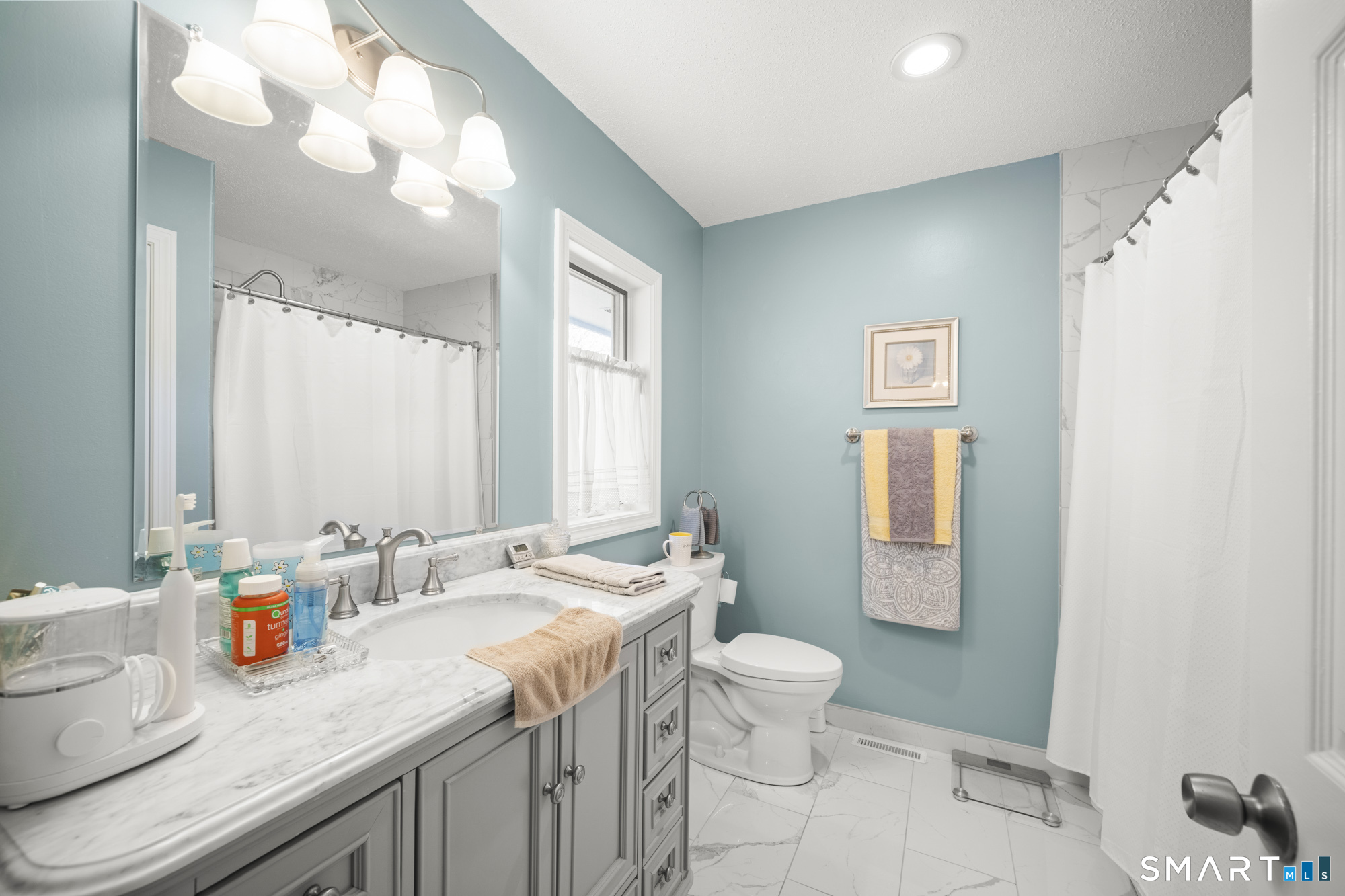 230 East Bass Lane, Unit 230 Suffield, CT 06078 - Photo 20 of 35 a bathroom with a granite countertop sink mirror vanity and toilet
