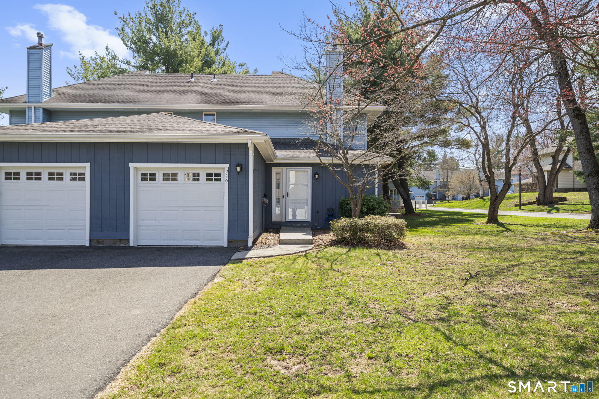 230 East Bass Lane, Unit 230 Suffield, CT 06078 - Photo 3 of 35 a view of a house with a yard and garage