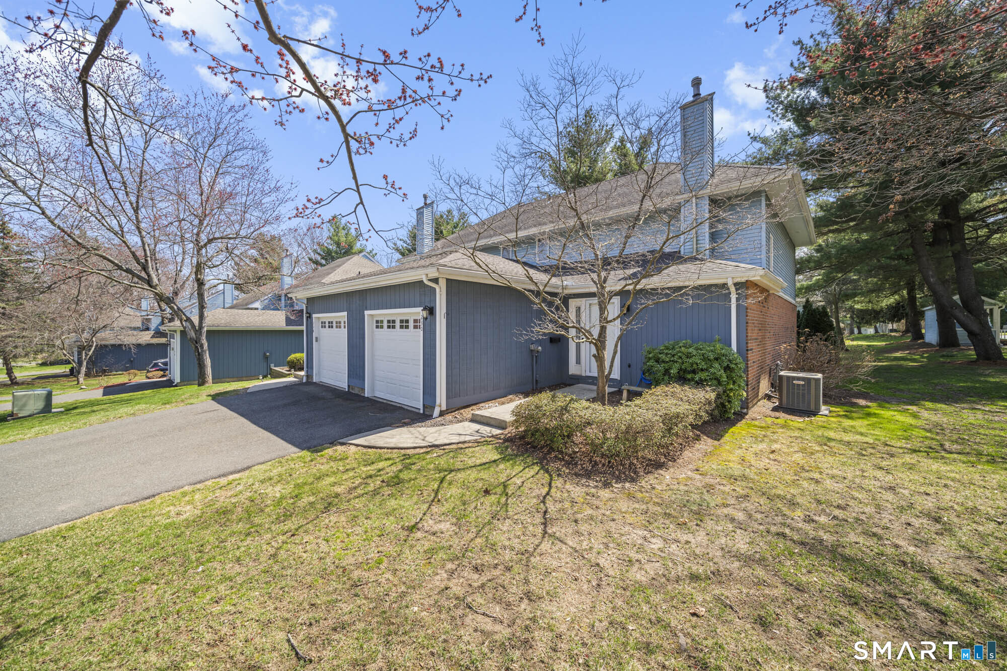 230 East Bass Lane, Unit 230 Suffield, CT 06078 - Photo 4 of 35 a view of a house with a yard and large tree