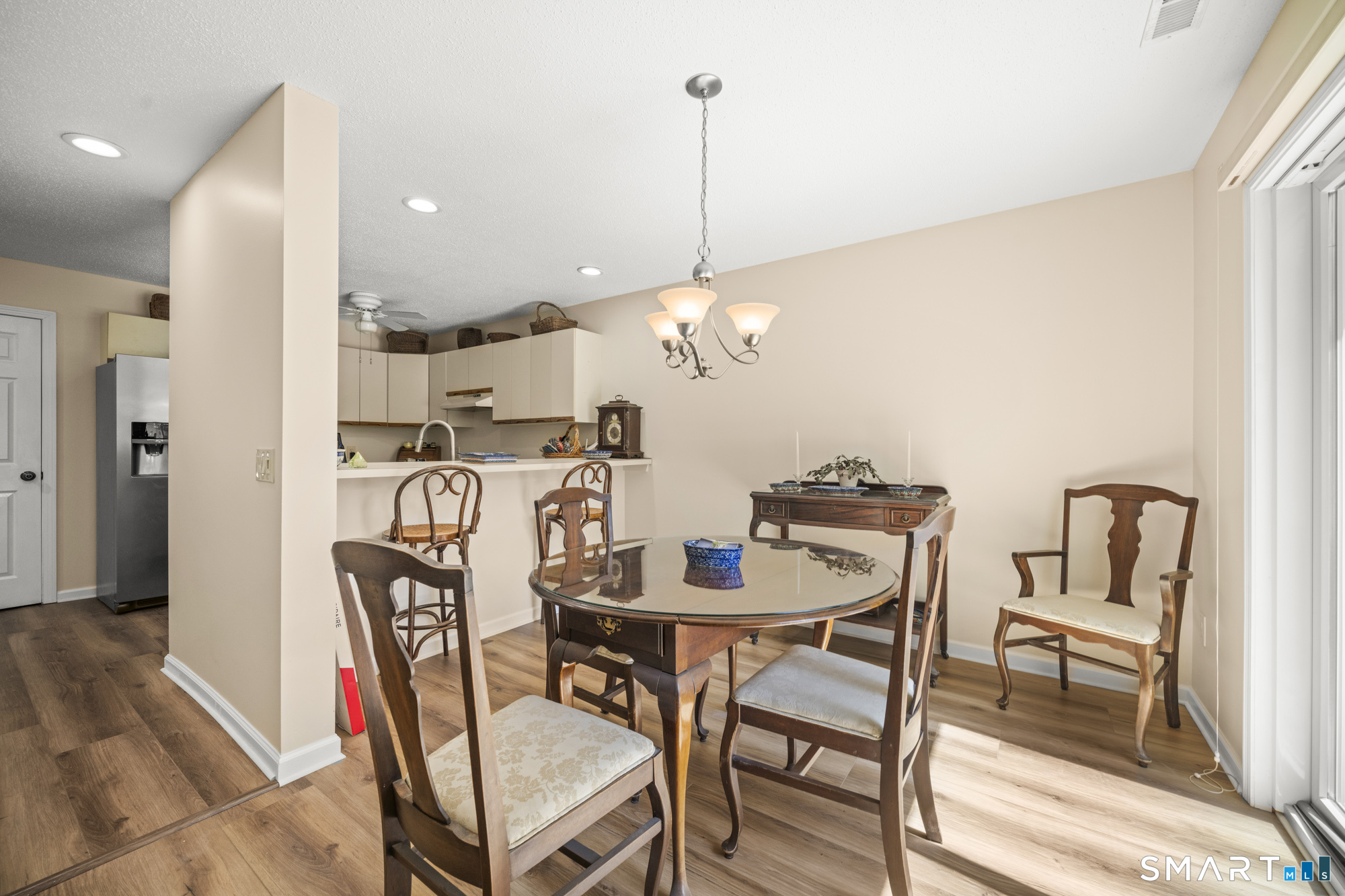 230 East Bass Lane, Unit 230 Suffield, CT 06078 - Photo 9 of 35 a dining room with furniture and wooden floor