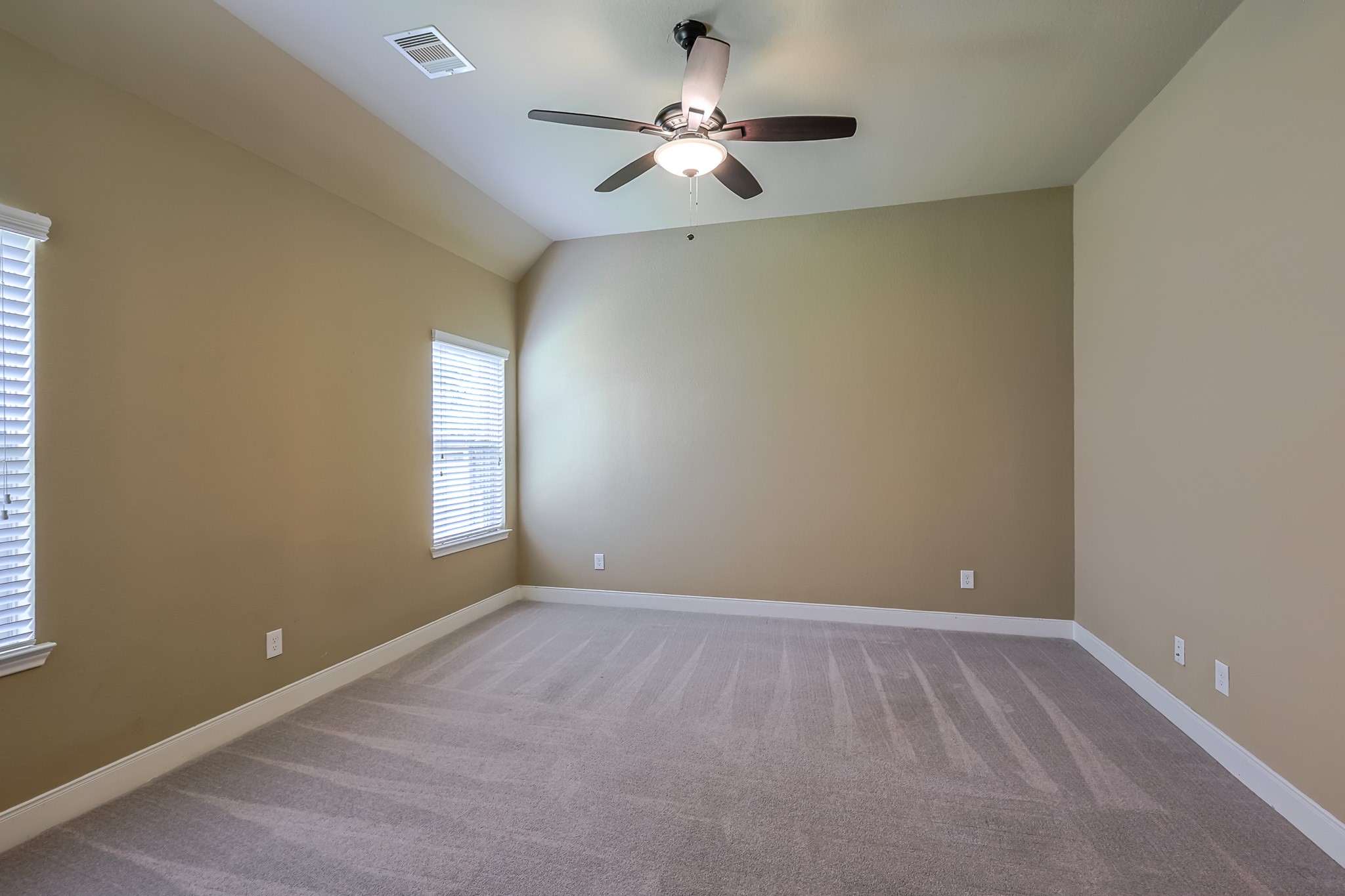 515 Mill Creek Road Pinehurst, TX 77362 - Photo 35 of 48 This is a spacious, carpeted bedroom with neutral walls, featuring a ceiling fan.
