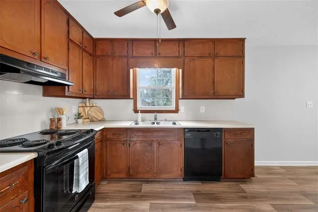 a kitchen with stainless steel appliances granite countertop a sink stove and cabinets