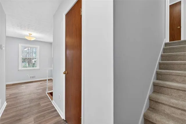 a view of a hallway with wooden floor and entryway