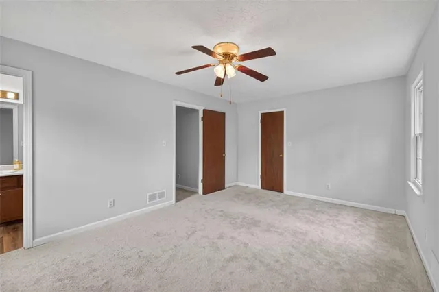 a view of a livingroom with a ceiling fan and window