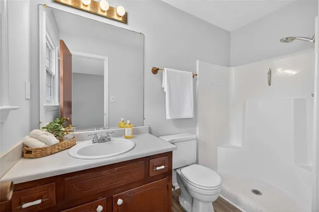 a bathroom with a sink toilet and shower