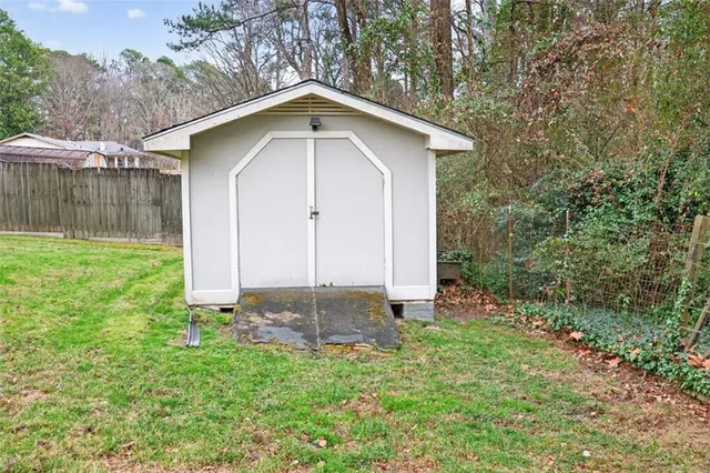 a small barn with a small yard in front of it