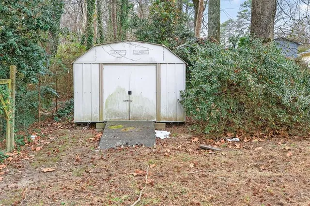 a backyard of a house with large trees and brick walls
