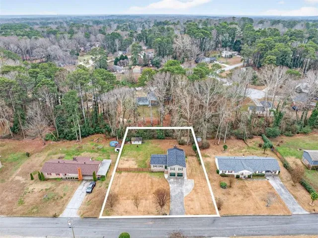 an aerial view of a house with a yard