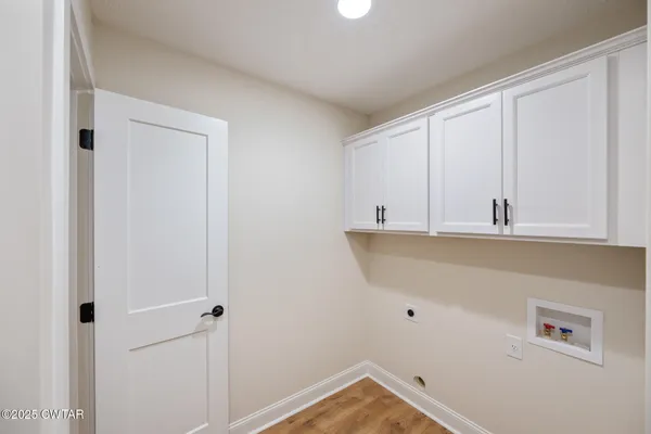 a view of kitchen with white cabinets
