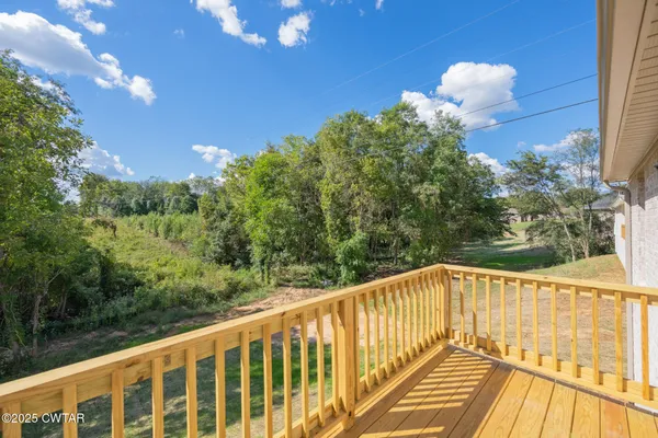 a view of balcony with wooden floor