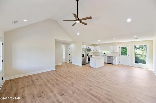 a view of a kitchen with a sink and window