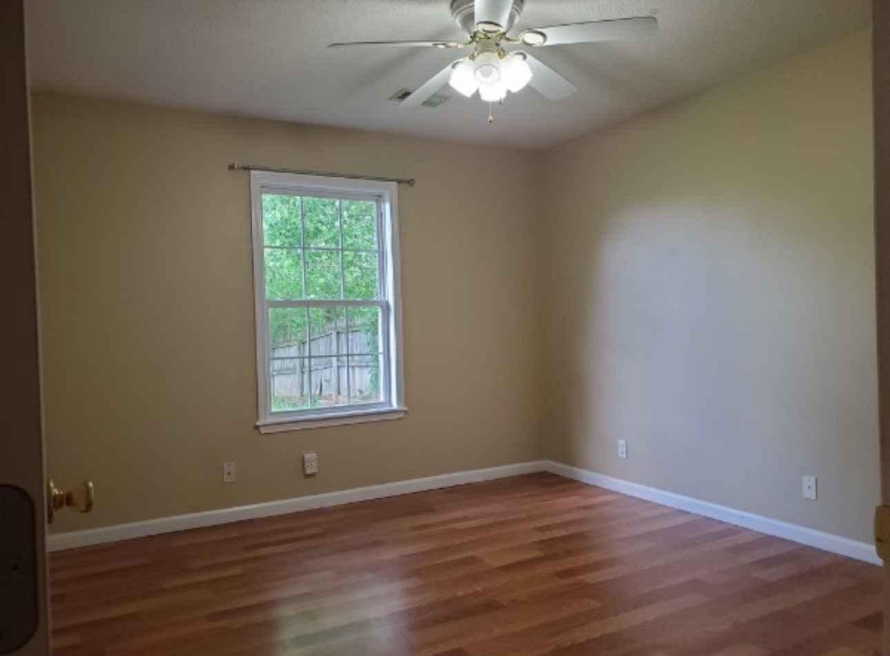 1058 Shadow Ridge Avenue Oak Grove, KY 42262 - Photo 7 of 7 a view of an empty room with wooden floor and a window