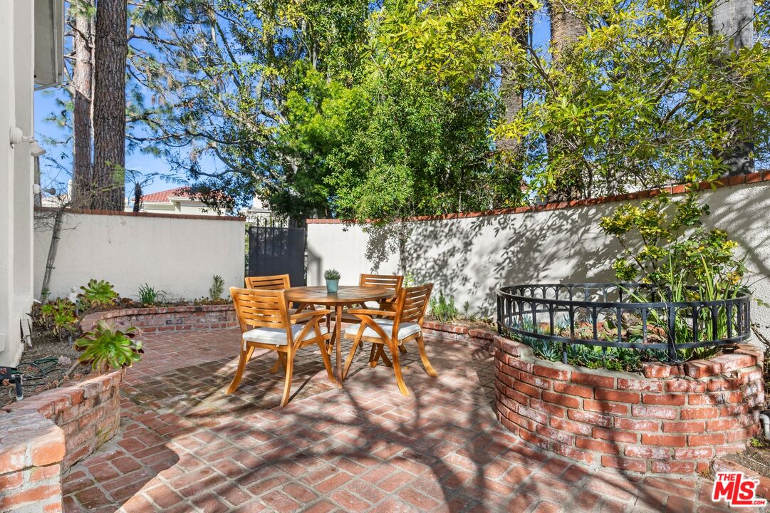12320 Ridge Circle Los Angeles, CA 90049 - Photo 12 of 38 a view of a patio with table and chairs and potted plants