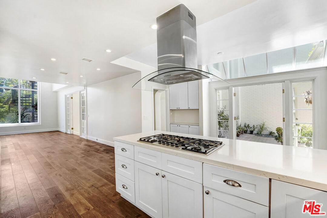 12320 Ridge Circle Los Angeles, CA 90049 - Photo 14 of 38 a kitchen with stainless steel appliances a counter space and a window