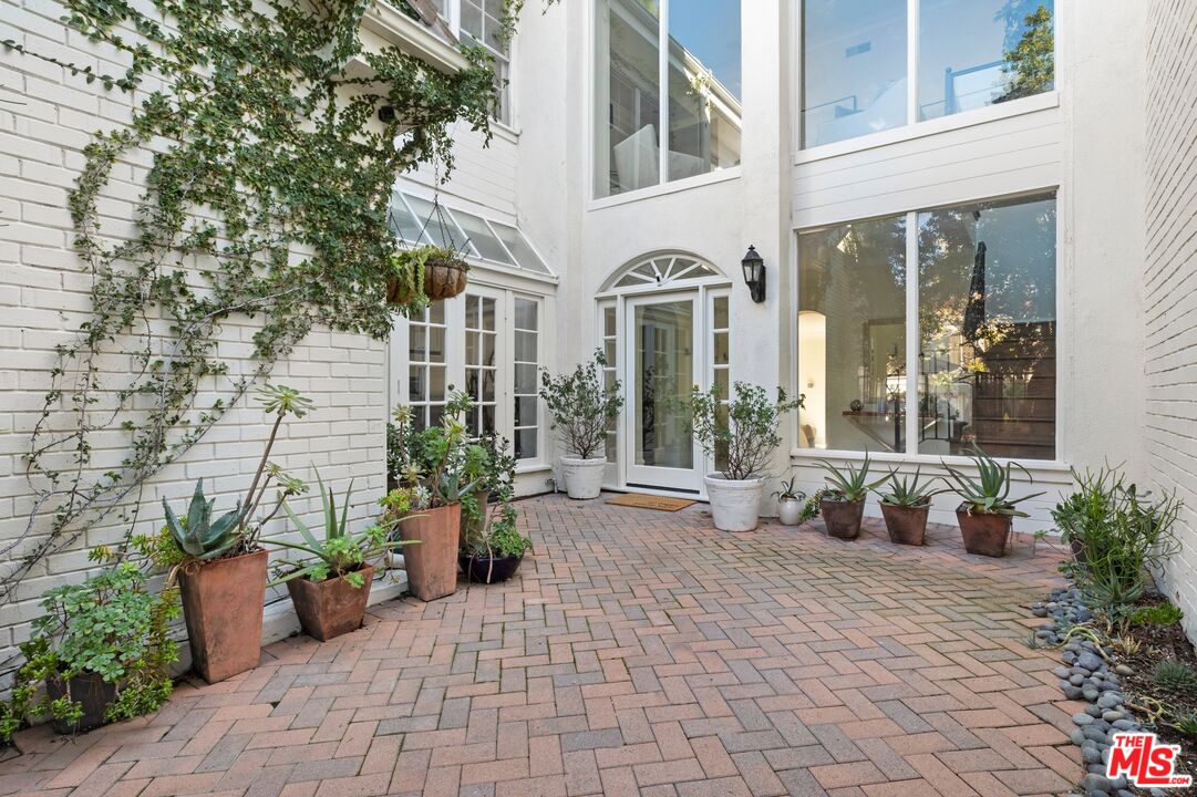 12320 Ridge Circle Los Angeles, CA 90049 - Photo 2 of 38 a view of a patio with chair and table potted plants
