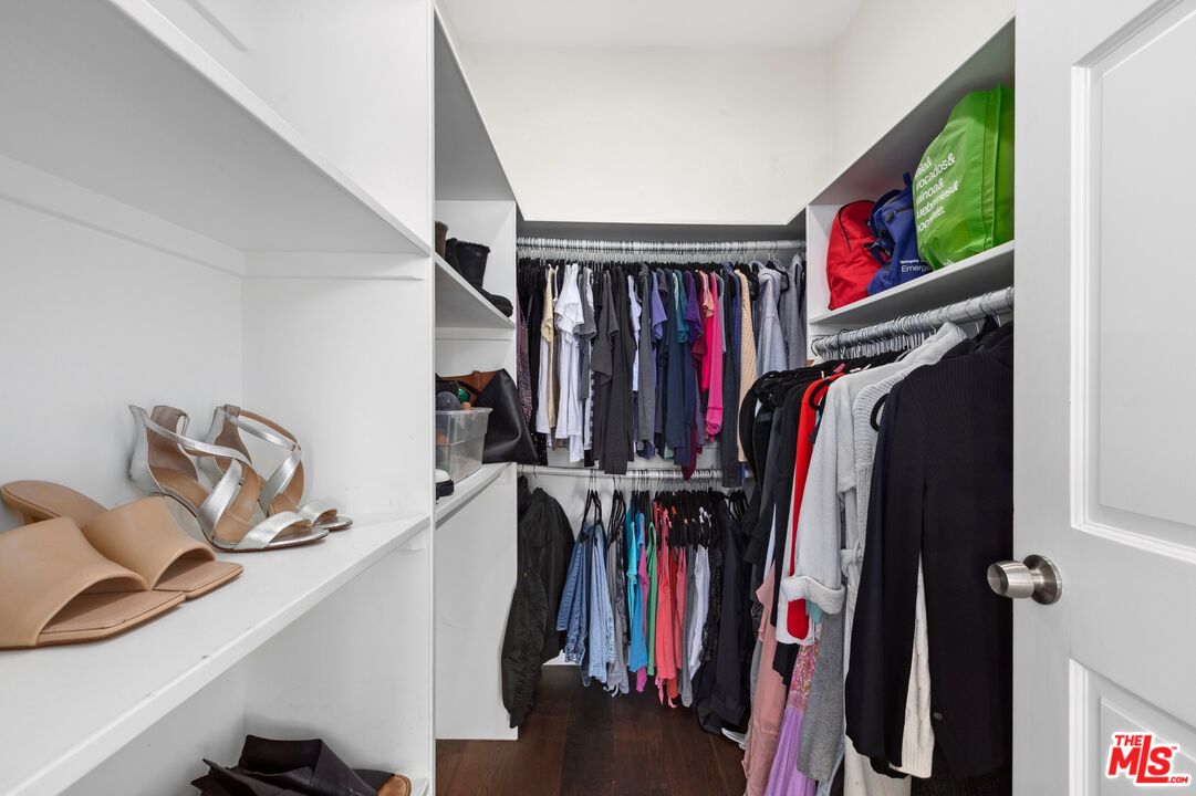 12320 Ridge Circle Los Angeles, CA 90049 - Photo 22 of 38 a view of walk in closet with clothes