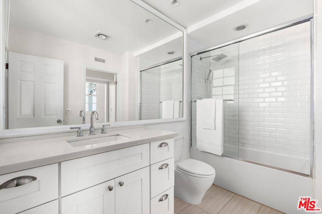 12320 Ridge Circle Los Angeles, CA 90049 - Photo 24 of 38 a bathroom with a granite countertop sink toilet and shower