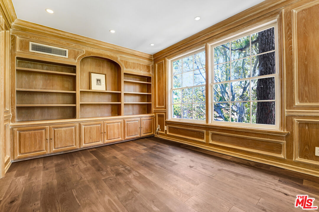 12320 Ridge Circle Los Angeles, CA 90049 - Photo 25 of 38 a view of an empty room with a window and wooden floor