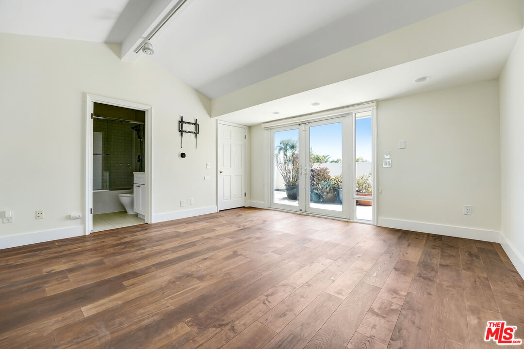 12320 Ridge Circle Los Angeles, CA 90049 - Photo 29 of 38 a view of an empty room with wooden floor and a window