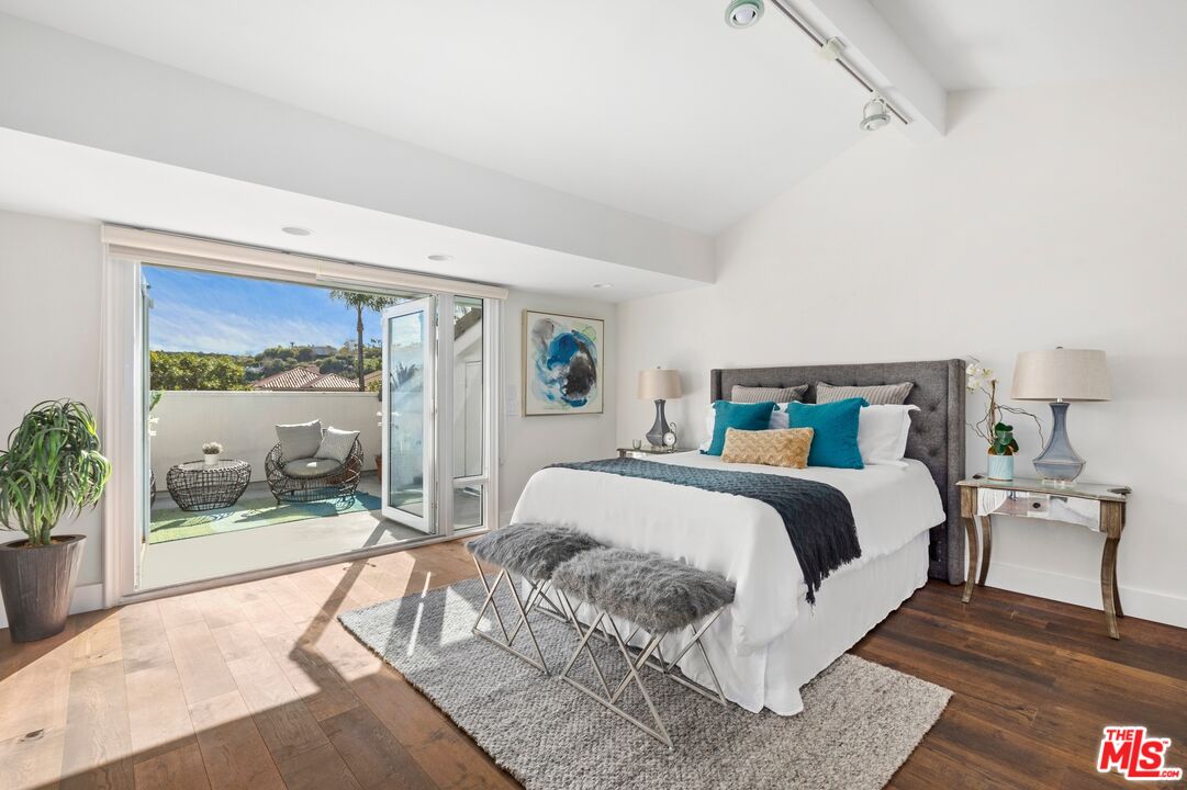 12320 Ridge Circle Los Angeles, CA 90049 - Photo 30 of 38 a bedroom with a bed and large window