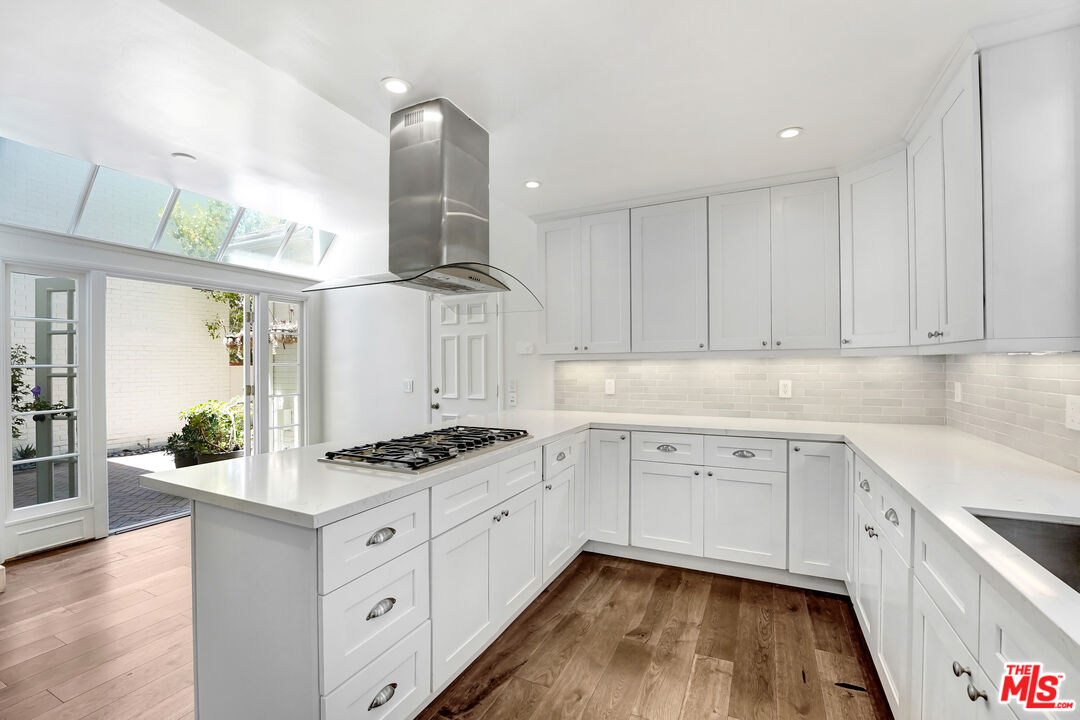 12320 Ridge Circle Los Angeles, CA 90049 - Photo 3 of 38 a kitchen with granite countertop a sink stove and cabinets