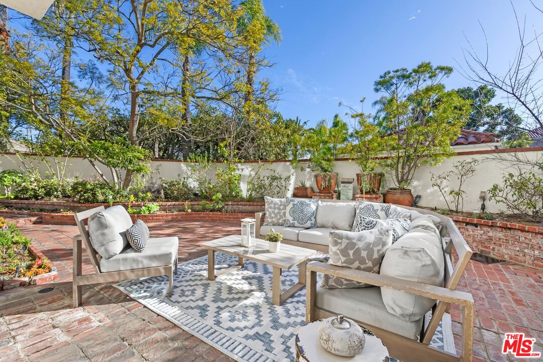 12320 Ridge Circle Los Angeles, CA 90049 - Photo 35 of 38 a view of a patio with couches table and chairs and potted plants