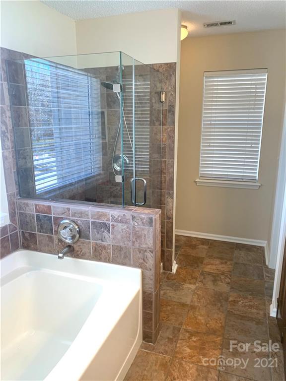 210 Forest Pond Road Kannapolis, NC 28083 - Photo 9 of 10 a bathroom with a tub a sink and a shower