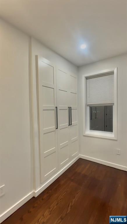 207 Valley Road, Unit 7 Clifton, NJ 07013 - Photo 7 of 8 a view of an empty room with wooden floor and a window