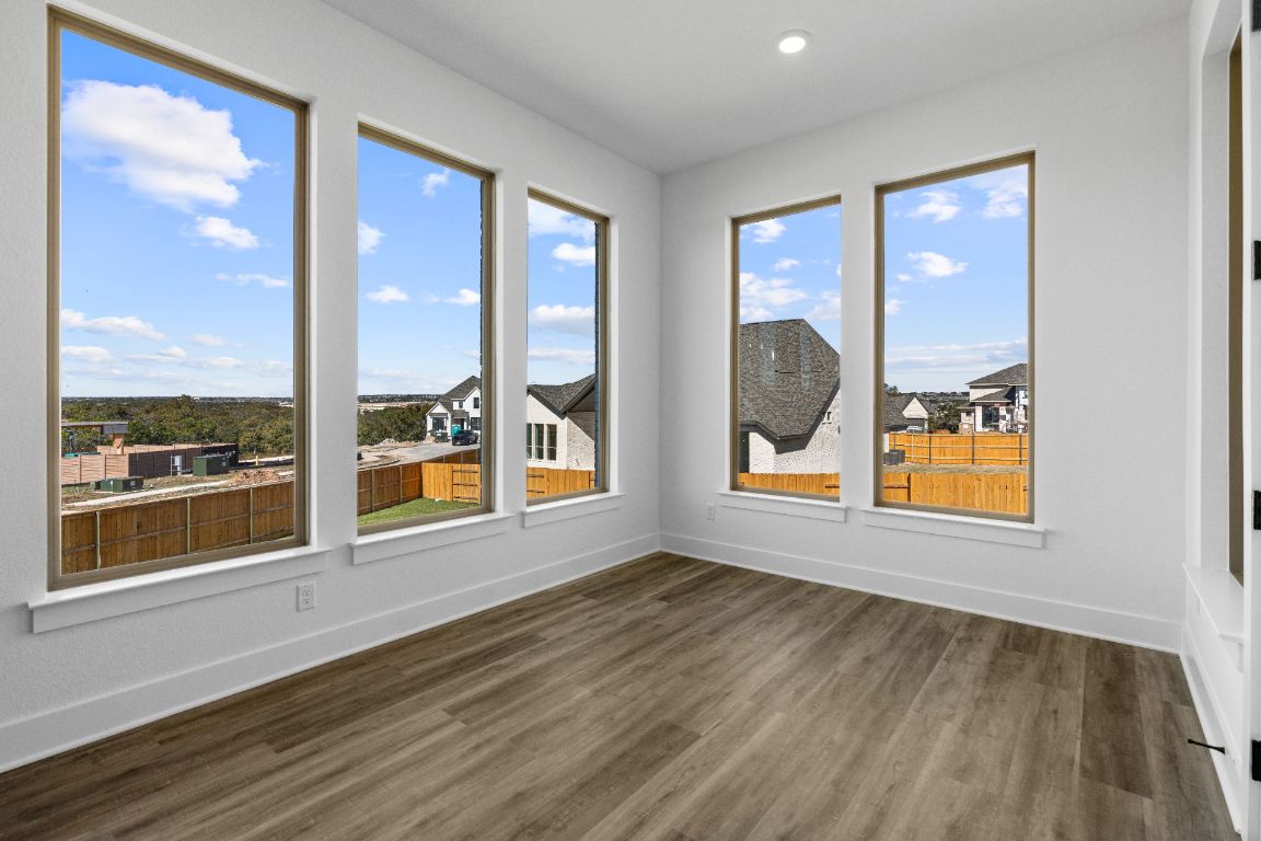 1620 Lilly Grace Bend Leander, TX 78641 - Photo 11 of 40 an empty room with wooden floor and windows