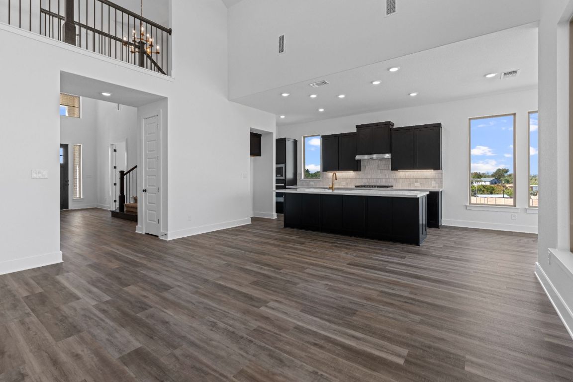 1620 Lilly Grace Bend Leander, TX 78641 - Photo 12 of 40 a view of kitchen with refrigerator stove and wooden floor