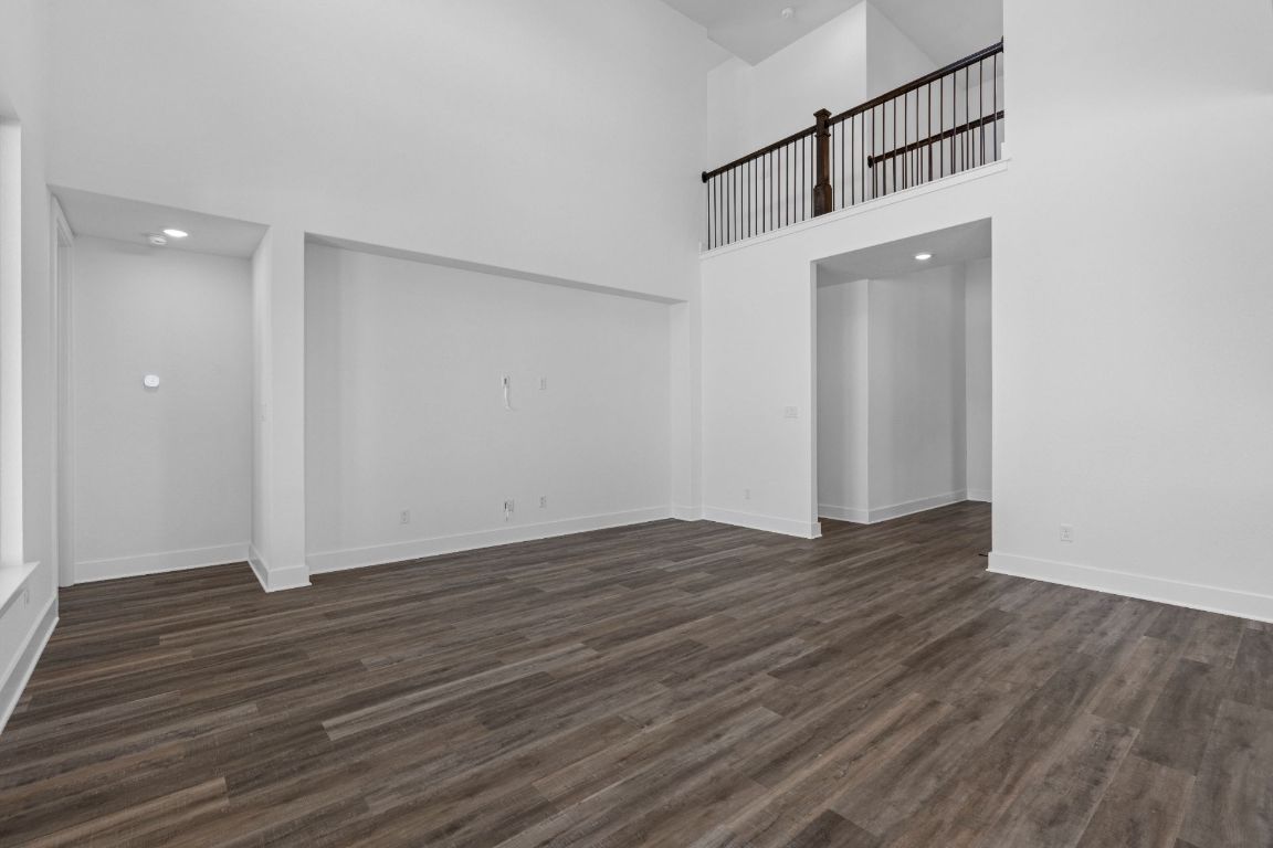 1620 Lilly Grace Bend Leander, TX 78641 - Photo 14 of 40 a view of an empty room with wooden floor and a window