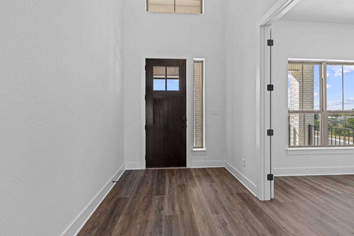1620 Lilly Grace Bend Leander, TX 78641 - Photo 3 of 40 an empty room with wooden floor and windows