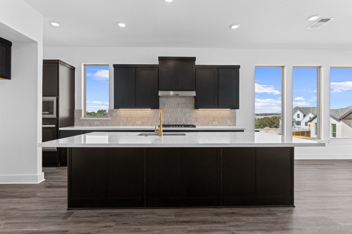 1620 Lilly Grace Bend Leander, TX 78641 - Photo 7 of 40 a view of kitchen with stainless steel appliances granite countertop a stove and a sink