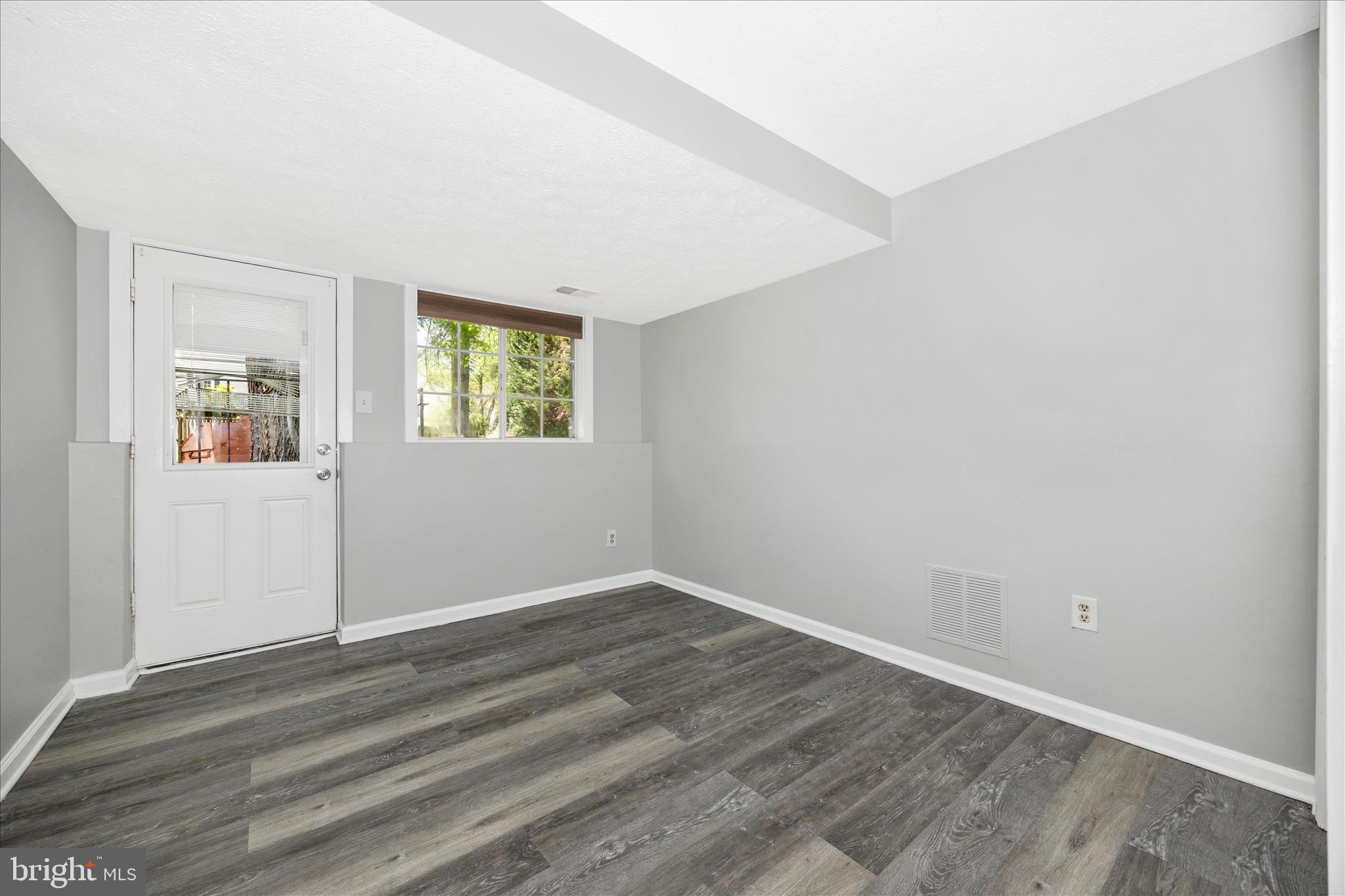 101 Andover Court Frederick, MD 21702 - Photo 16 of 29 an empty room with wooden floor and windows
