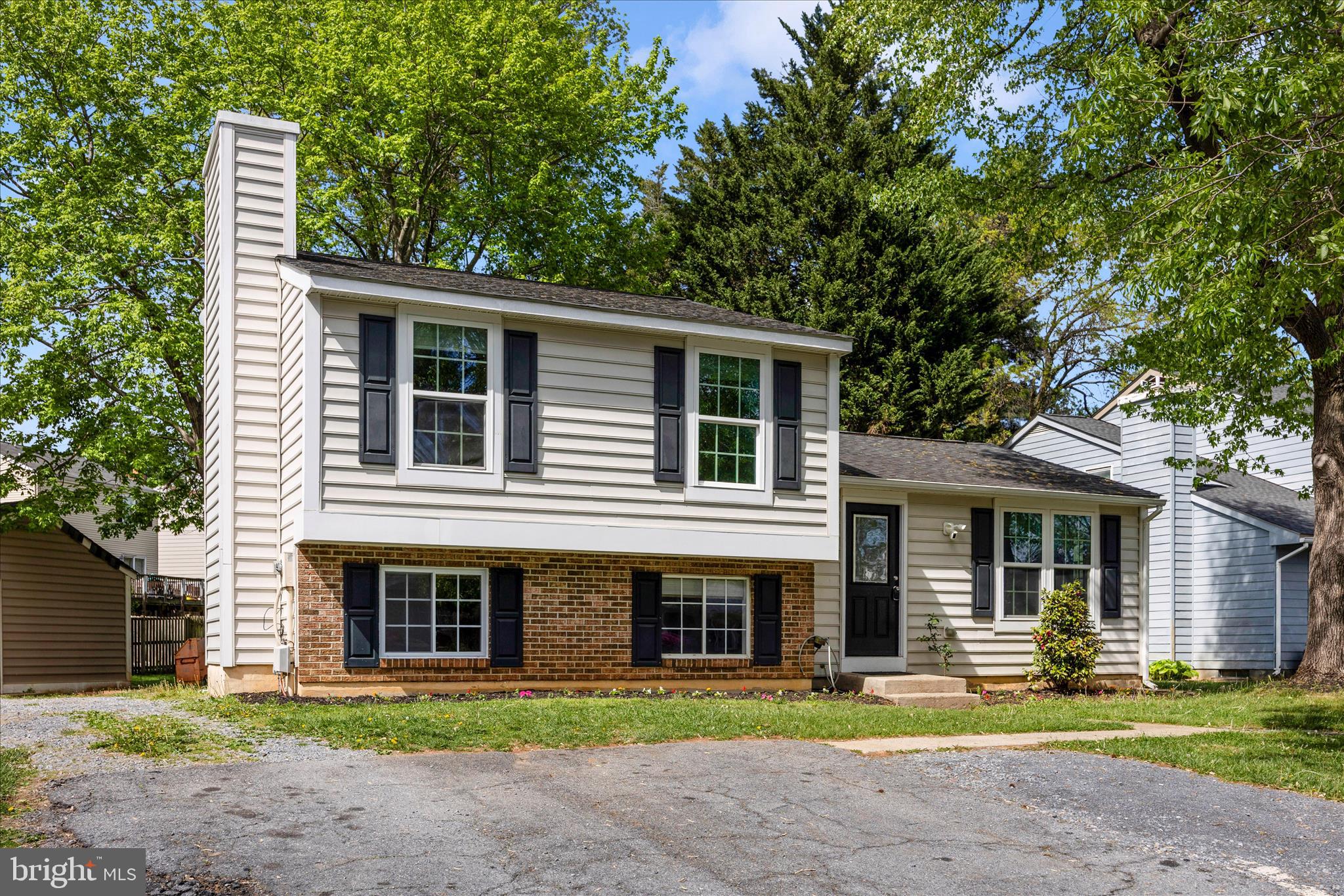 101 Andover Court Frederick, MD 21702 - Photo 28 of 29 a front view of a house with a garden and trees