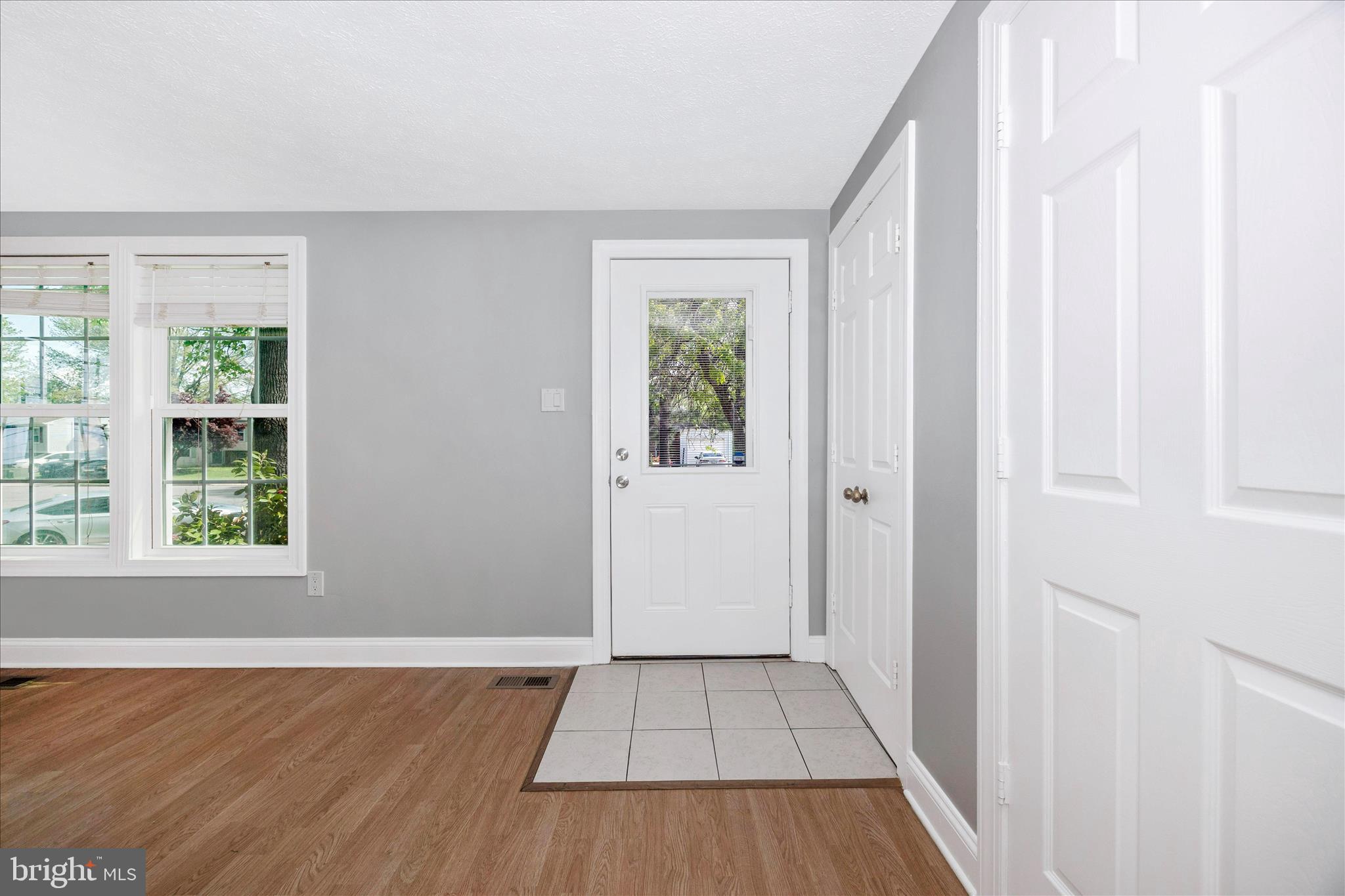 101 Andover Court Frederick, MD 21702 - Photo 3 of 29 an empty room with wooden floor and windows
