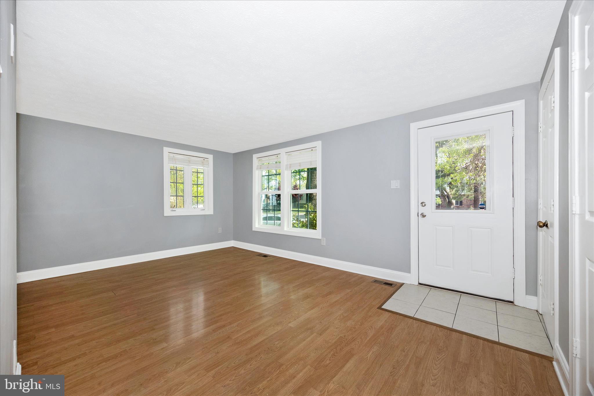 101 Andover Court Frederick, MD 21702 - Photo 4 of 29 an empty room with wooden floor and windows