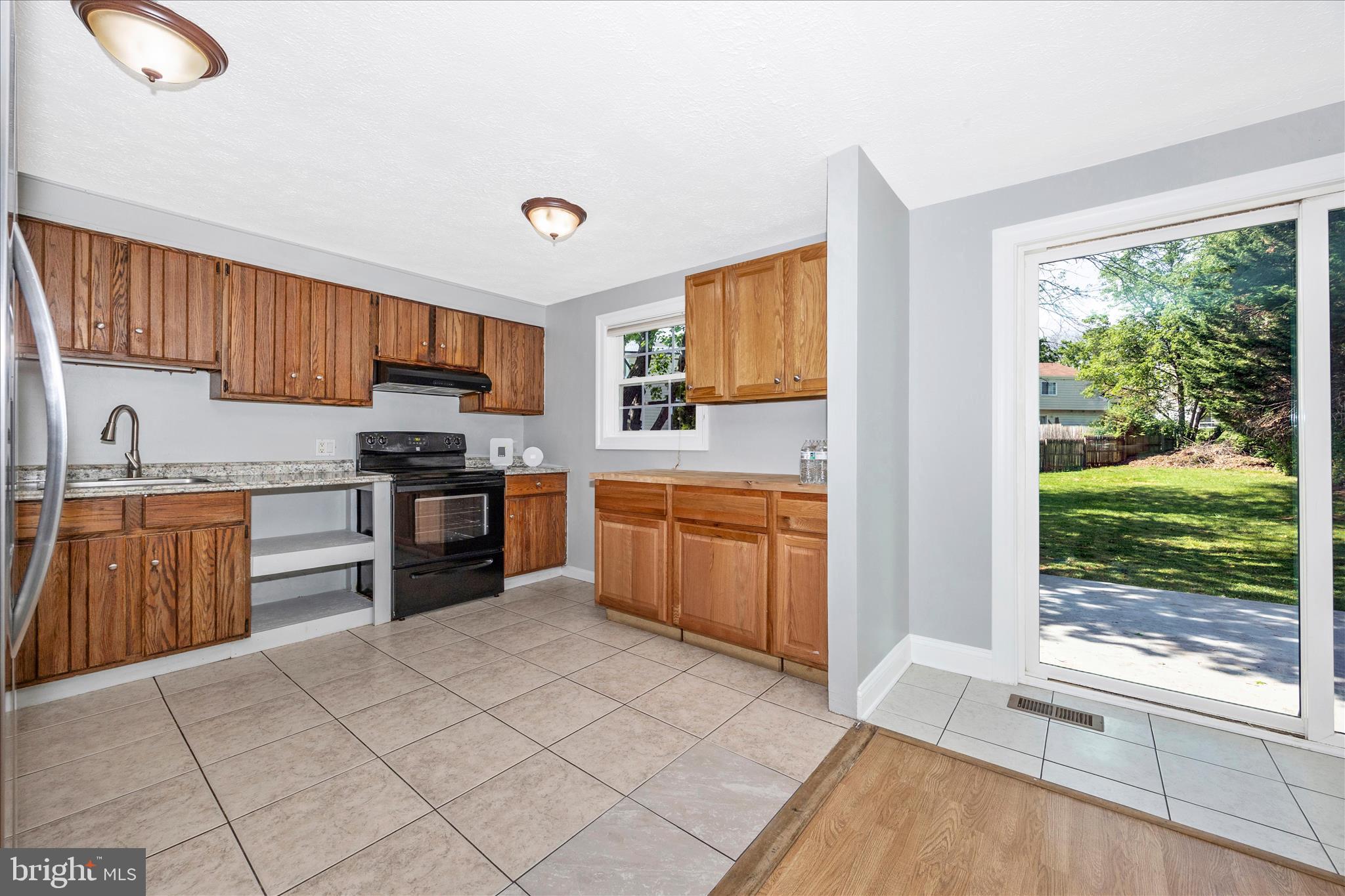 101 Andover Court Frederick, MD 21702 - Photo 6 of 29 a kitchen with stainless steel appliances granite countertop a stove top oven a sink dishwasher and a refrigerator with wooden cabinets