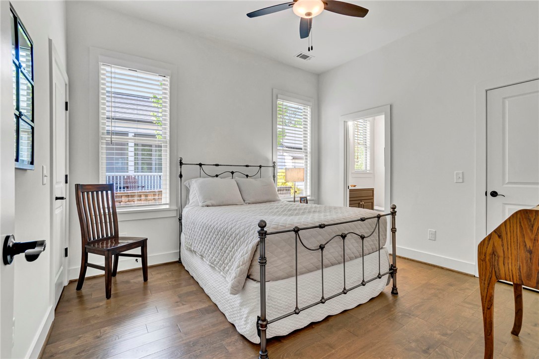 308 Pershing Avenue Clemson, SC 29631 - Photo 14 of 31 This cozy bedroom features bright windows and rich hardwood flooring, perfect for serene living.