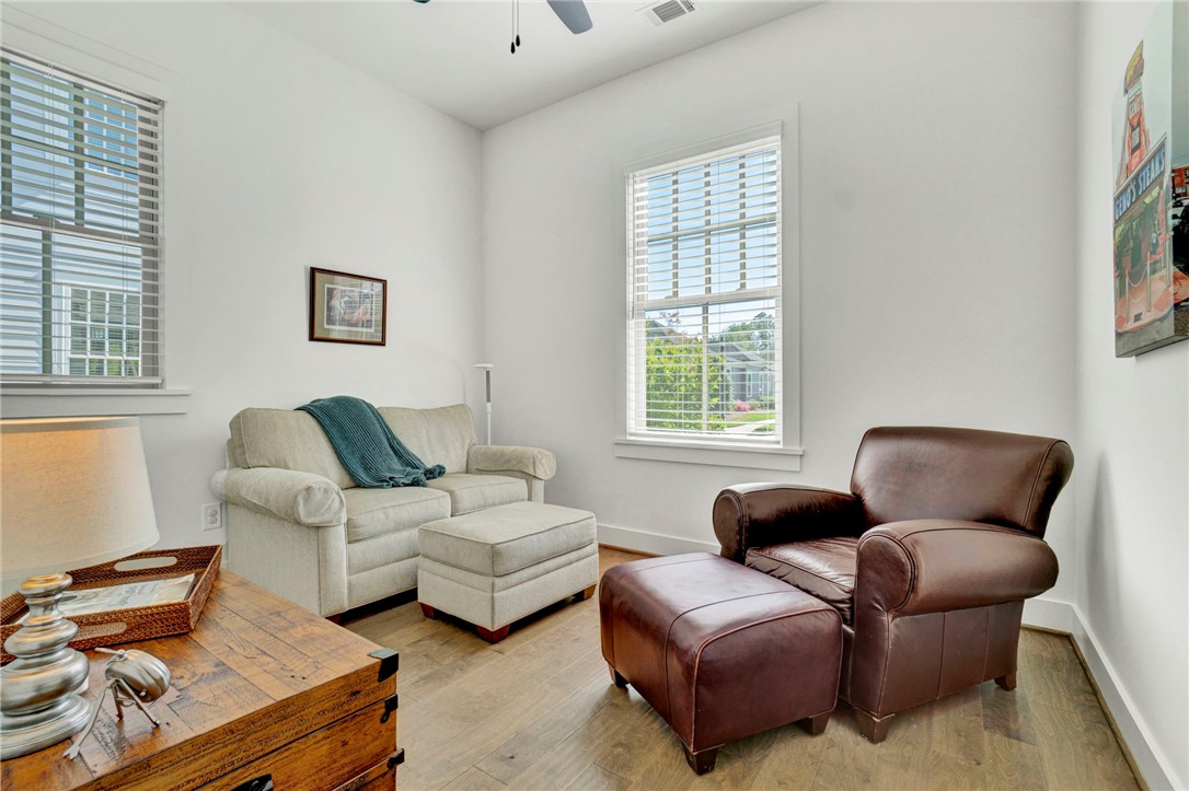 308 Pershing Avenue Clemson, SC 29631 - Photo 18 of 31 Bright and airy living area featuring light-toned walls and elegant hardwood flooring.
