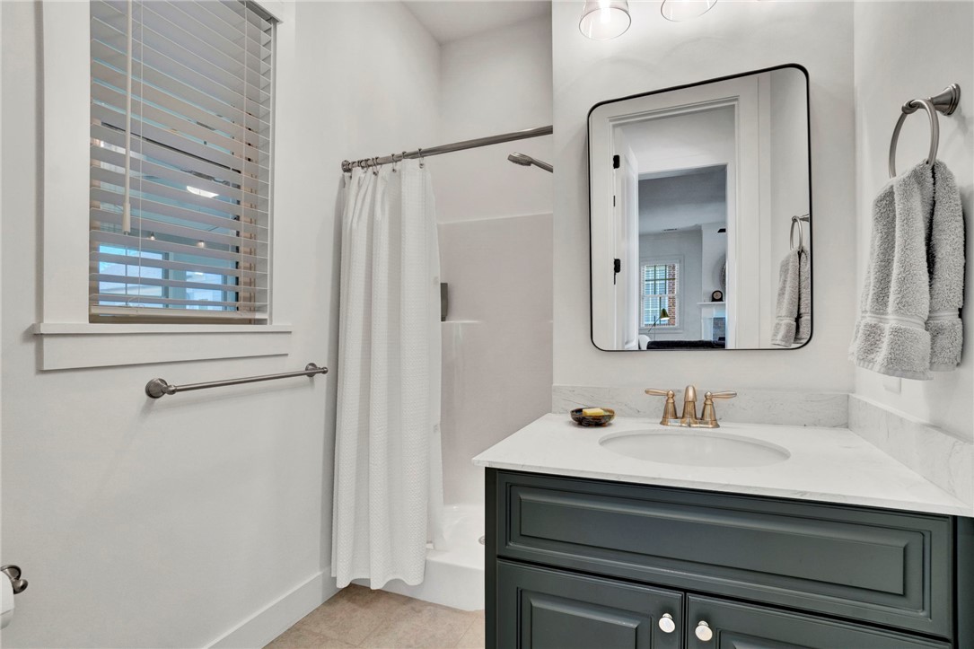 308 Pershing Avenue Clemson, SC 29631 - Photo 20 of 31 This bathroom features a contemporary vanity with a sleek countertop and an inviting shower area.