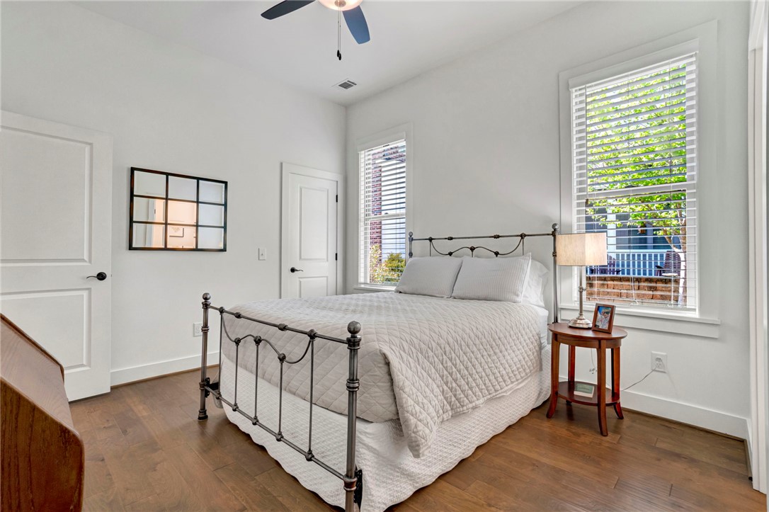 308 Pershing Avenue Clemson, SC 29631 - Photo 22 of 31 Bright and airy bedroom featuring rich hardwood flooring and large windows, perfect for serene living.